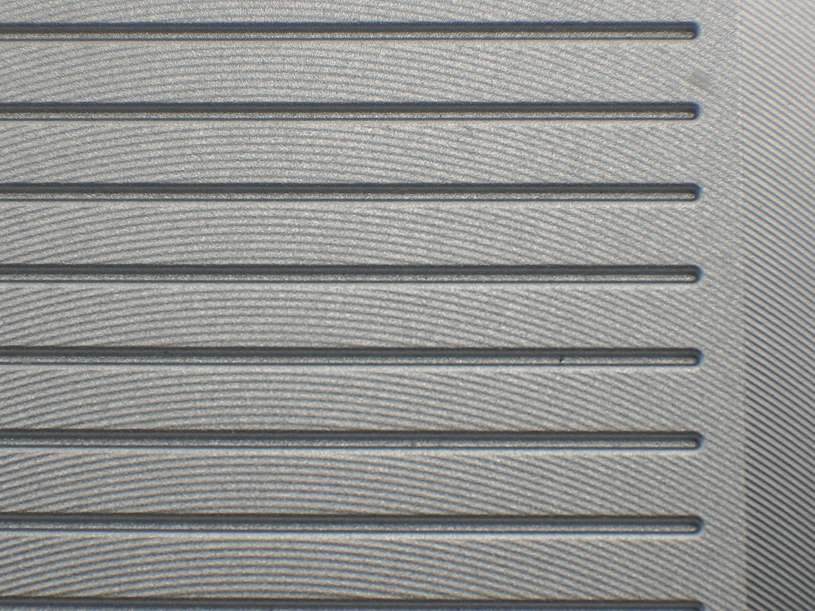 Close-up of the micro milled F1 face showing the fine CNC texture between the grooves