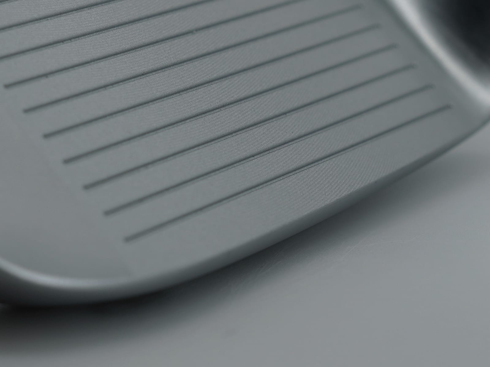 The F1 iron face and leading edge, showing the relief of the crescent V-shaped sole